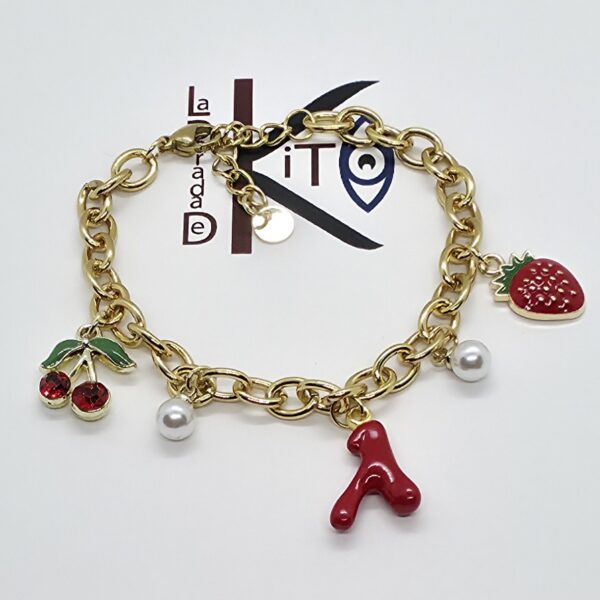 Pulsera de acero dorado con colgantes frutales y marinos